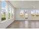 Bright living room featuring multiple windows for natural light and wood-look floors at 553 Winding Creek Dr, Lillington, NC 27546