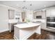 Modern kitchen featuring gray cabinets, stainless steel appliances, and island at 601 Copper Beech Ln, Wake Forest, NC 27587