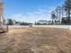 Large backyard with a white fence and a storage shed, offering plenty of space for outdoor activities at 61 Andrews Landing Dr, Wendell, NC 27591