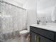 Bathroom featuring vanity with granite countertop, chrome faucet, and decorative shower curtain at 61 Andrews Landing Dr, Wendell, NC 27591