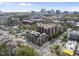 Aerial view of brick apartment buildings and city skyline at 615 W Peace St # 301, Raleigh, NC 27605