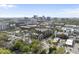 Wide aerial of cityscape with brick apartment building nestled among mature trees at 615 W Peace St # 301, Raleigh, NC 27605