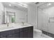 Modern bathroom featuring double sink vanity, white subway tile shower, and black hexagonal flooring at 615 W Peace St # 301, Raleigh, NC 27605