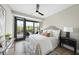 This bedroom is bright and airy with modern decor and a ceiling fan at 615 W Peace St # 301, Raleigh, NC 27605
