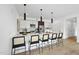 Modern kitchen features a large island with seating, stainless steel appliances, and stylish pendant lighting at 615 W Peace St # 301, Raleigh, NC 27605