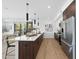 Modern kitchen features a large island with seating, stainless steel appliances, and stylish pendant lighting at 615 W Peace St # 301, Raleigh, NC 27605