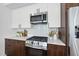 Modern kitchen features stainless steel appliances, white countertops, dark wood cabinets, and subway tile backsplash at 615 W Peace St # 301, Raleigh, NC 27605