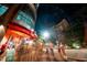 Exterior view of a BBQ bar at night with a modern building design and lively street scene at 615 W Peace St # 301, Raleigh, NC 27605