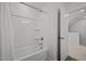 All-white bathroom with a standard tub/shower and a convenient built-in shelf at 63 Capewood Ct, Garner, NC 27529