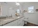 Bright bathroom features double vanity, granite countertops, and a large mirror at 63 Capewood Ct, Garner, NC 27529