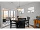 Charming dining area features a round table, black chairs, and sliding door access to the screened porch at 63 Capewood Ct, Garner, NC 27529