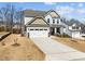 Charming home featuring a two-car garage, a well-manicured lawn, and a welcoming front porch at 63 Capewood Ct, Garner, NC 27529