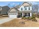 Charming two-story home features a two-car garage, inviting front porch, and beautifully landscaped front yard at 63 Capewood Ct, Garner, NC 27529