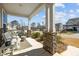 View from the front porch, showing the bench, stone columns, and neighborhood street with well-maintained homes at 63 Capewood Ct, Garner, NC 27529