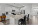 Bright kitchen features white cabinetry, stainless appliances, granite countertops and a center island with seating at 63 Capewood Ct, Garner, NC 27529