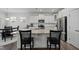 Bright kitchen with a granite island, stainless steel appliances, white cabinets, and breakfast table at 63 Capewood Ct, Garner, NC 27529