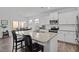 Kitchen island with granite countertops, stainless steel appliances, white cabinetry and bar stool seating at 63 Capewood Ct, Garner, NC 27529