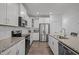 Modern kitchen boasts granite counters, subway tile backsplash, stainless appliances, and white cabinetry at 63 Capewood Ct, Garner, NC 27529
