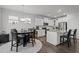 Bright eat-in kitchen featuring granite counters, white cabinetry, stainless steel appliances and adjacent dining area at 63 Capewood Ct, Garner, NC 27529