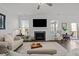 Cozy living room features a fireplace with large-screen TV, neutral tones, and access to a screened porch at 63 Capewood Ct, Garner, NC 27529