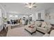 Spacious open-concept living area that connects the kitchen and dining with a beautiful area rug and a ceiling fan at 63 Capewood Ct, Garner, NC 27529