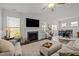 Inviting living room featuring a fireplace, large windows, hardwood floors, and access to the dining area at 63 Capewood Ct, Garner, NC 27529