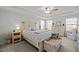 Spacious primary bedroom with tray ceilings, a ceiling fan, large windows and charming, neutral decor at 63 Capewood Ct, Garner, NC 27529