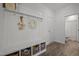 Organized mudroom area with bench, hooks, and storage baskets at 63 Capewood Ct, Garner, NC 27529