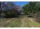 Backyard with partial view of home with small screened-in porch and lots of trees at 632 E Franklin St, Raleigh, NC 27604