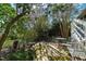 Serene backyard featuring a brick patio with outdoor seating, lush greenery, and a tranquil garden area at 632 E Franklin St, Raleigh, NC 27604