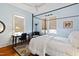 Bright bedroom with wood floors, natural light, desk, and seating area at 632 E Franklin St, Raleigh, NC 27604