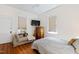 Comfortable bedroom with wood floors, natural light, and a chaise lounge at 632 E Franklin St, Raleigh, NC 27604