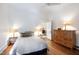 Bedroom with hardwood floors, side tables, and a wooden dresser at 632 E Franklin St, Raleigh, NC 27604