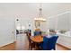 Elegant dining room with wood table, blue chairs, and ample natural light at 632 E Franklin St, Raleigh, NC 27604