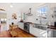 Bright kitchen features stainless steel appliances, farmhouse sink, butcher block counters, and hardwood floors at 632 E Franklin St, Raleigh, NC 27604