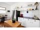 Well-lit kitchen with white cabinets, open shelving, and a stained glass window at 632 E Franklin St, Raleigh, NC 27604