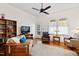 Cozy living room featuring hardwood floors, a ceiling fan, and natural light at 632 E Franklin St, Raleigh, NC 27604