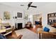 Bright living room with fireplace, hardwood floors, and comfortable seating arrangement at 632 E Franklin St, Raleigh, NC 27604