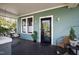 Inviting covered porch with a swing, seating, and a classic black front door at 632 E Franklin St, Raleigh, NC 27604