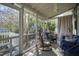 Inviting sunroom with ample natural light, ceiling fan, comfortable seating, and views of the surrounding landscape at 632 E Franklin St, Raleigh, NC 27604