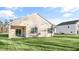 Backyard featuring a lush lawn, a covered patio, and a view of neighboring homes at 71 Hawksmoore Ln, Lillington, NC 27546