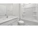 Pristine bathroom featuring a tub-shower combination, white vanity and toilet at 71 Hawksmoore Ln, Lillington, NC 27546