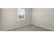 Cozy carpeted bedroom features natural light from the window and neutral colored walls at 71 Hawksmoore Ln, Lillington, NC 27546
