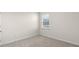 Bedroom with carpet flooring, a window and white trim at 71 Hawksmoore Ln, Lillington, NC 27546