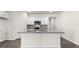 Open kitchen featuring granite countertops, stainless appliances, and a functional island with bar seating at 71 Hawksmoore Ln, Lillington, NC 27546