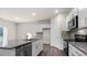 Modern kitchen featuring white cabinets, stainless steel appliances, and a large island with granite countertops at 71 Hawksmoore Ln, Lillington, NC 27546