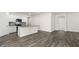 Open concept living space featuring kitchen with island and view into the spacious living area at 71 Hawksmoore Ln, Lillington, NC 27546