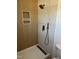 Stylish walk-in shower has wood look accent wall, tile surround, and overhead shower fixture at 82 Cool Creek Dr, Willow Springs, NC 27592