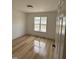 Well-lit bedroom showcasing wood flooring and a window providing natural light and a view at 82 Cool Creek Dr, Willow Springs, NC 27592
