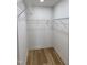 Walk-in closet with wood flooring, wire shelves, and ample storage space at 82 Cool Creek Dr, Willow Springs, NC 27592